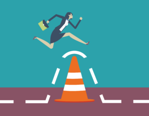skills gap - woman jumping over traffic cone with briefcase